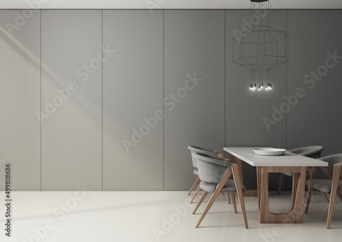 Wnętrze nowoczesnej, minimalistycznej jadalni z szarymi panelami na ścianie i białą epoksydową posadzką.