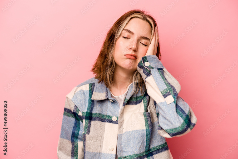 Young caucasian woman isolated on pink background tired and very sleepy keeping hand on head. Young caucasian woman isolated on pink background tired and very sleepy keeping hand on head.