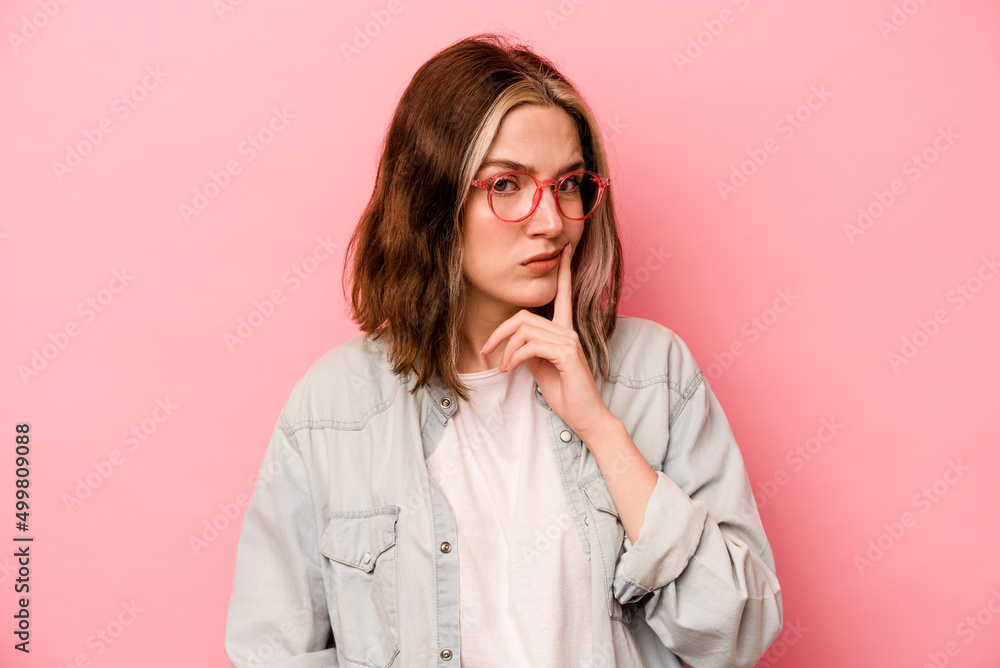 Young caucasian woman isolated on pink background contemplating, planning a strategy, thinking about the way of a business. Young caucasian woman isolated on pink background contemplating, planning a strategy, thinking about the way of a business.