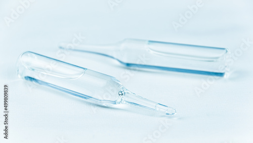 Glass ampoules for injection. Liquid medicine for preparation of solution. Pharmaceutical business, sale of medicines. Symbol of vaccination in hospital