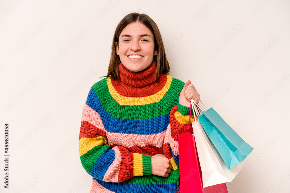 Young caucasian woman going to shopping isolated on white background laughing and having fun. Young caucasian woman going to shopping isolated on white background laughing and having fun.