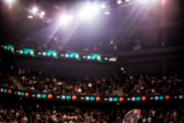 blurred background of supporters at sports event crowd of people in a basketball court