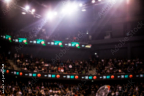 blurred background of supporters at sports event crowd of people in a basketball court photo