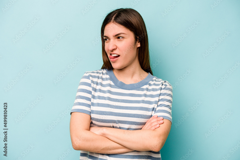 Young caucasian woman isolated on blue background funny and friendly sticking out tongue. Young caucasian woman isolated on blue background funny and friendly sticking out tongue.