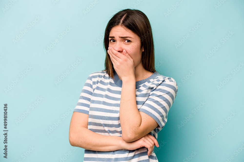 Young caucasian woman isolated on blue background scared and afraid. Young caucasian woman isolated on blue background scared and afraid.