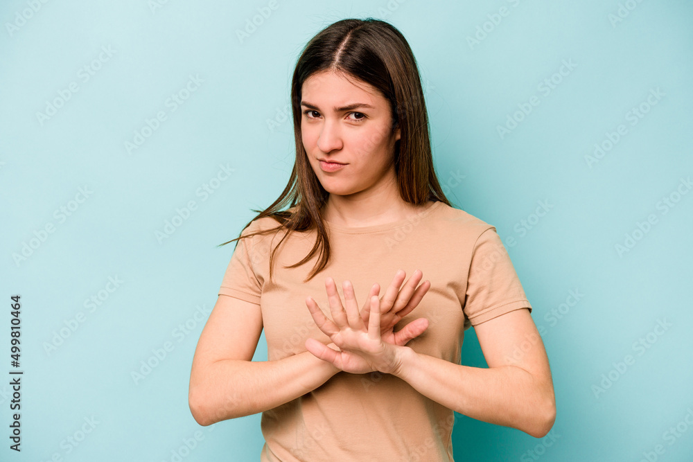 Young caucasian woman isolated on blue background doing a denial gesture Young caucasian woman isolated on blue background doing a denial gesture