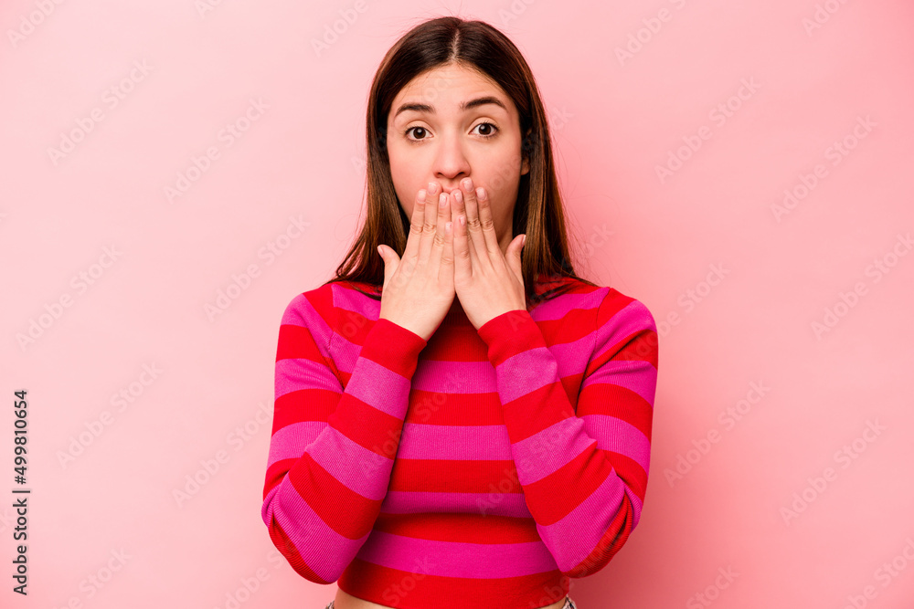 Young caucasian woman isolated on pink background shocked, covering mouth with hands, anxious to discover something new. Young caucasian woman isolated on pink background shocked, covering mouth with hands, anxious to discover something new.