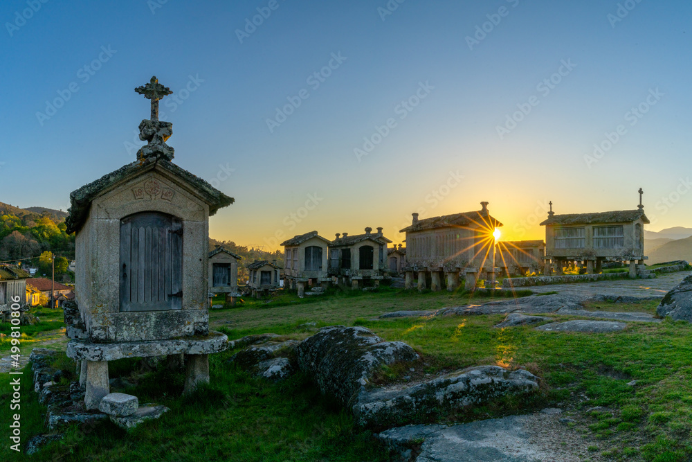 evening light over granaries and stone storage sheds in the village of Lindoso in Portugal evening light over granaries and stone storage sheds in the village of Lindoso in Portugal