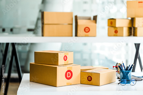 Cardboard box delivery logistic prepare at SME shop, modern office. © makibestphoto
