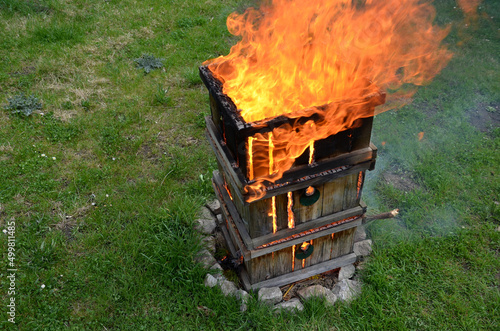 during the plague epidemic at apiary, it is necessary to ensure hygienic burning of all hives and tools that came into contact with sick bees. sad event and view of burning beekeeping equipment photo