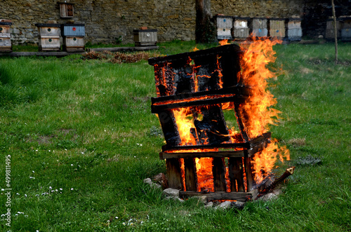 during the plague epidemic at apiary, it is necessary to ensure hygienic burning of all hives and tools that came into contact with sick bees. sad event and view of burning beekeeping equipment photo