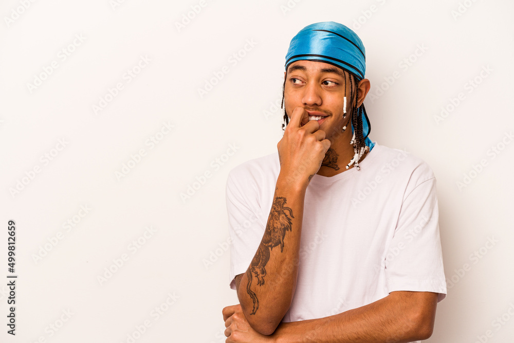 Young African American man isolated on white background relaxed thinking about something looking at a copy space. Young African American man isolated on white background relaxed thinking about something looking at a copy space.