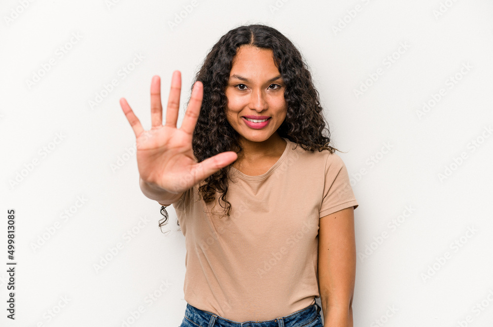 Young hispanic woman isolated on white background smiling cheerful showing number five with fingers. Young hispanic woman isolated on white background smiling cheerful showing number five with fingers.