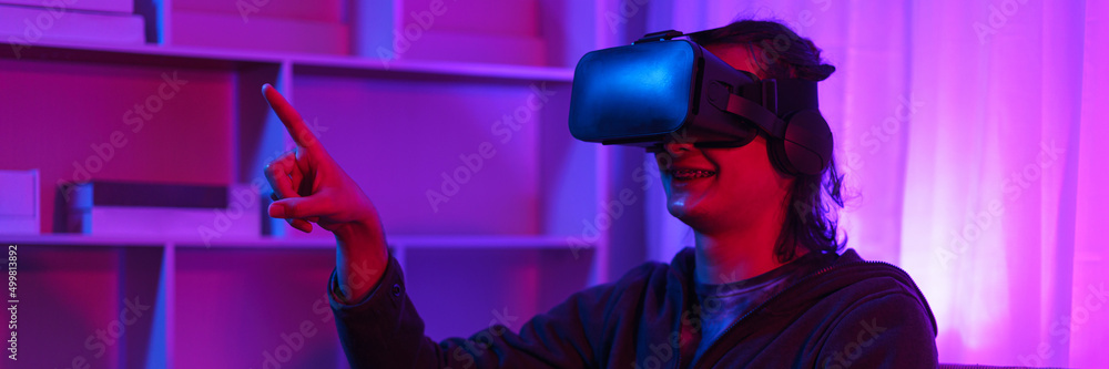 Metaverse technology concept, Man wear VR goggles and pointing to touch experience in virtual world Metaverse technology concept, Man wear VR goggles and pointing to touch experience in virtual world
