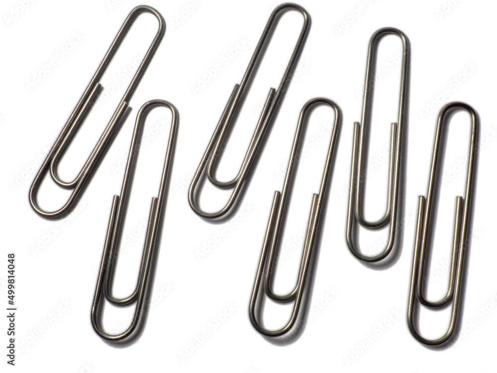 Metal paper clips on a white background. office supplies. isolated Metal paper clips on a white background. office supplies. isolated