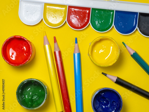 Wallpaper Mural Jars of paint and pencils on a yellow background. Banks of gouache.  Creative background. Artist's workshop. Torontodigital.ca