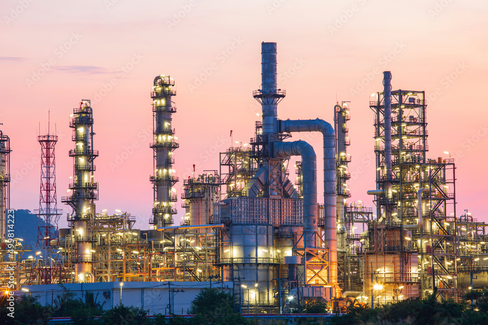 Oil refinery and plant and tower column of Petrochemistry industry in oil and gas industrial with cloud red sky Oil refinery and plant and tower column of Petrochemistry industry in oil and gas industrial with cloud red sky