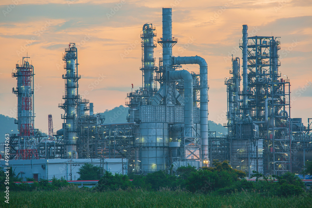 Oil refinery and plant and tower column of Petrochemistry industry in oil and gas industrial with cloud red sky Oil refinery and plant and tower column of Petrochemistry industry in oil and gas industrial with cloud red sky