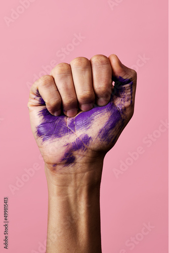 clenched fist with stains of purple paint photo