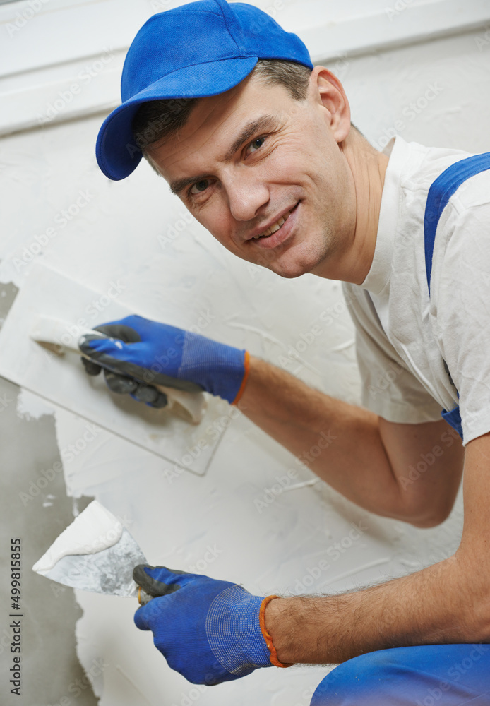 Plasterwork and wall painting preparation. craftsman applying plaster or filling Plasterwork and wall painting preparation. craftsman applying plaster or filling