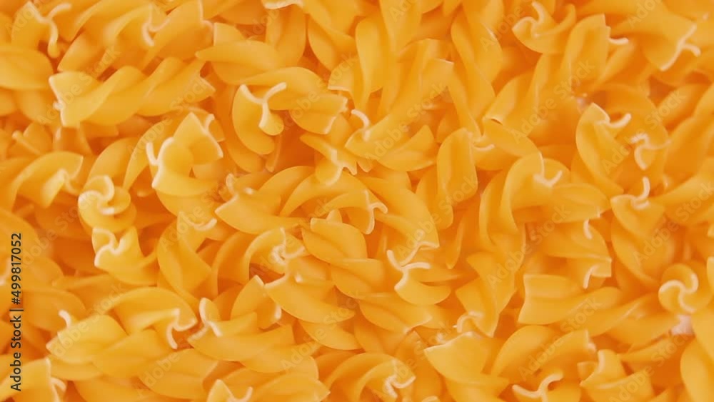 Uncooked Fusilli Pasta - Top View. Fat and Unhealthy Food. Dry Spiral Macaroni, Rotating Background. Italian Culture and Cuisine. Raw Golden Pasta Pattern. Left Rotation Uncooked Fusilli Pasta - Top View. Fat and Unhealthy Food. Dry Spiral Macaroni, Rotating Background. Italian Culture and Cuisine. Raw Golden Pasta Pattern. Left Rotation