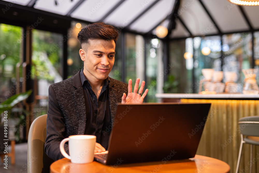 Portrait of handsome young businessman using laptop in coffee shop Portrait of handsome young businessman using laptop in coffee shop