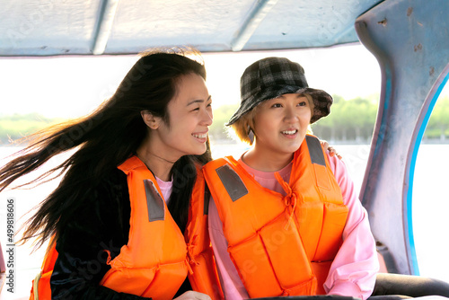 Two Asian Girls in Happy Moment Having Fun Outdoors on Boat.