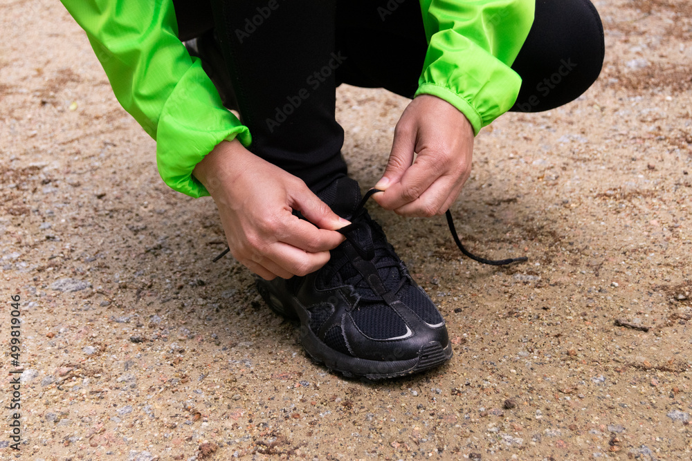 person tying their shoelaces.
