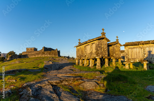 Lindoso Castle and historic stone granaries in the village of Lindoso in Portugal in warm evening light