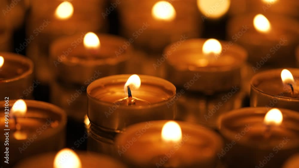 Many small burning candles on a black background Many small burning candles on a black background