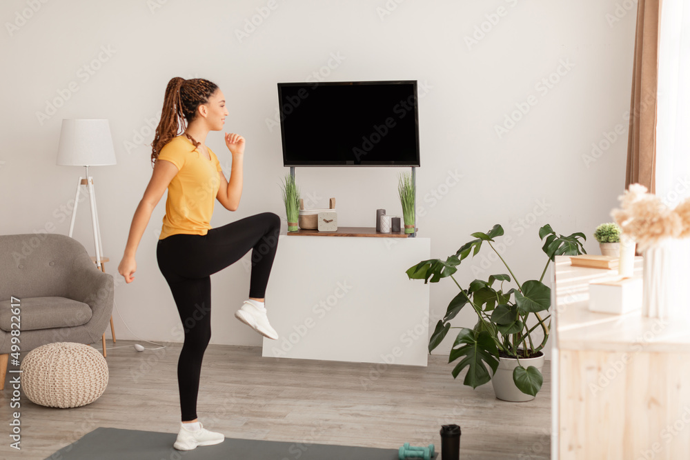 African American Lady Doing Knee To Elbow Leg Exercise Indoor African American Lady Doing Knee To Elbow Leg Exercise Indoor