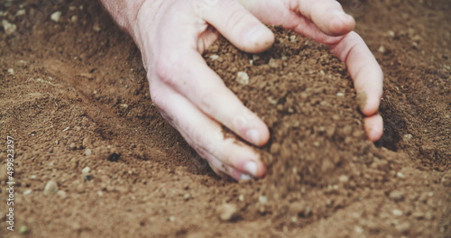 Farmer holding soil in hands. field.