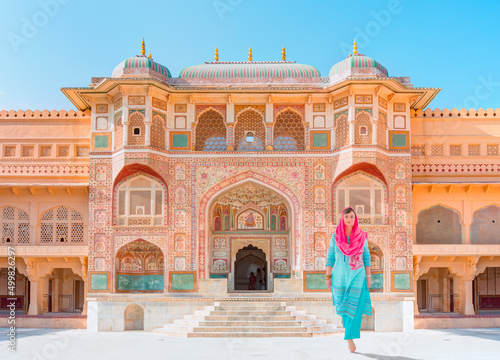 Photos An Indian woman dressed in traditional costume walks between columns - Columned