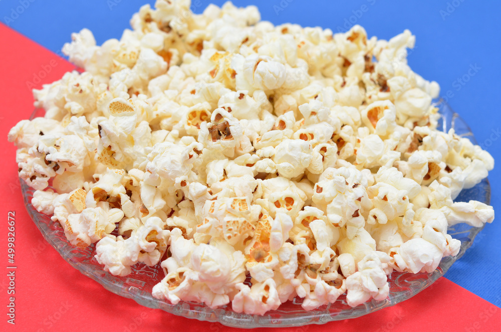 a plate of popcorn close-up on a red-blue background symbolizing 3 d cinema a plate of popcorn close-up on a red-blue background symbolizing 3 d cinema