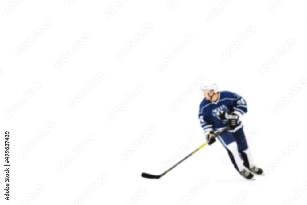 Obraz premium Active movement of hockey players on ice at speed in dynamics - out of focus hockey player on ice - blur hockey match on background