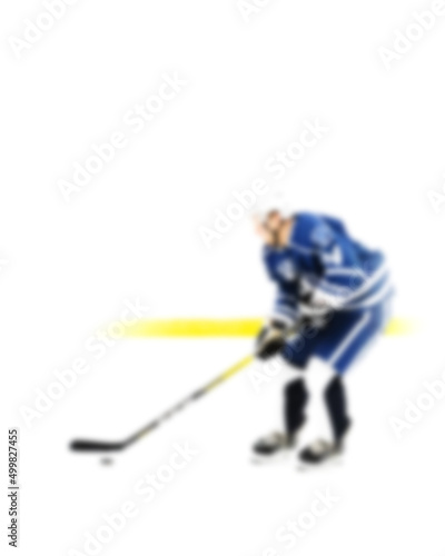 Photography Hockey player in blue uniform in motion on the ice - out of focus hockey player