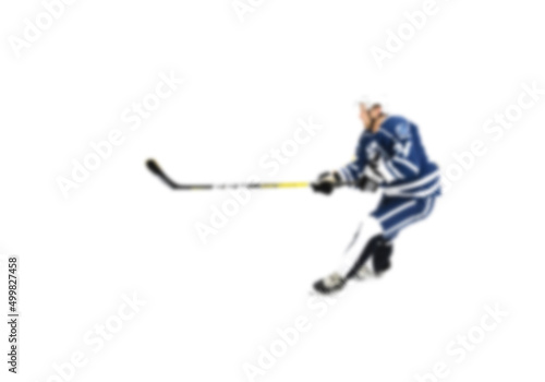 Hockey player in blue uniform in motion on the ice - out of focus hockey player on ice - blur hockey match on background © andrey gonchar