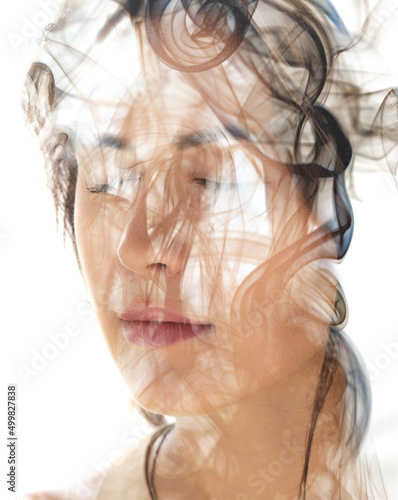 An image of smoke combined with a portrait of a young woman
