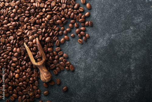 Coffee beans background. Roasted Coffee beans on dark black stone background. Top view. Coffee concept. Mock up.