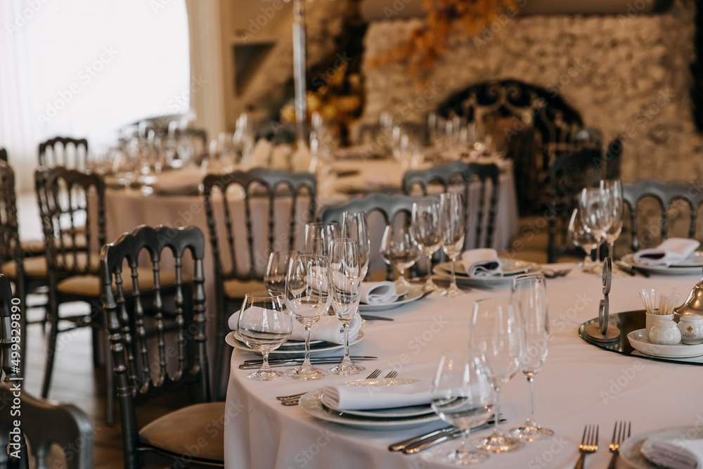 Table setting in a luxury restaurant with glasses and plates. Table setting in a luxury restaurant with glasses and plates.