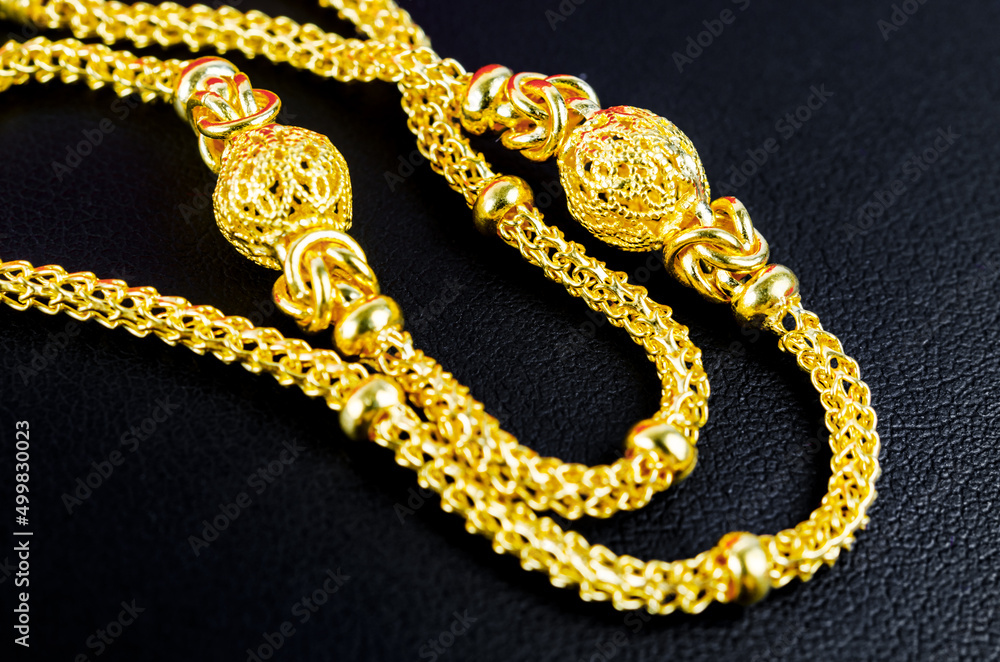 The Gold necklace on black leather. The Gold necklace on black leather.