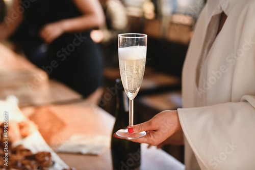 Bride holding a glass of champagne at a wedding