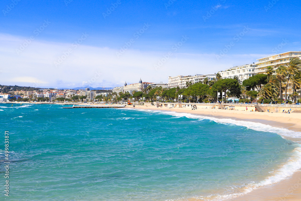 The beach, beach promenade and the town Cannes - France