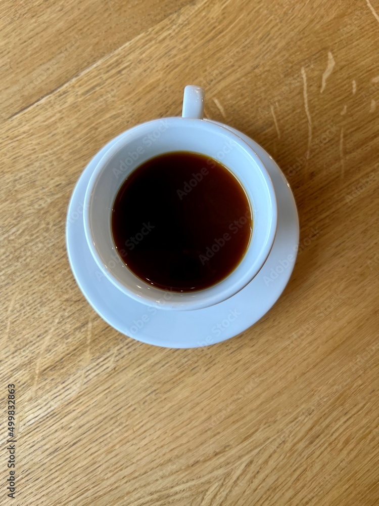 cup of coffee on wooden table in a cafe cup of coffee on wooden table in a cafe