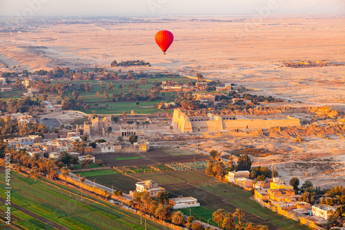 Hot air balloon flying above The Mortuary Temple of Ramesses III at Medinet Habu. photo