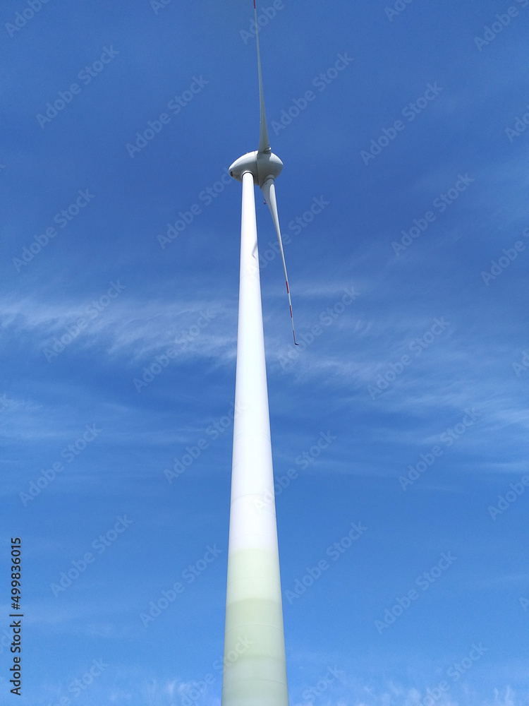 Windmill for electric power production against blue sky. Windmill for electric power production against blue sky.
