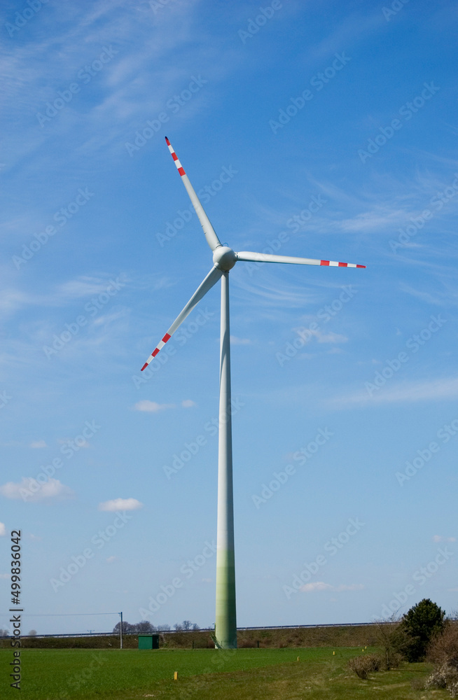 Windmill for electric power production against blue sky. Windmill for electric power production against blue sky.