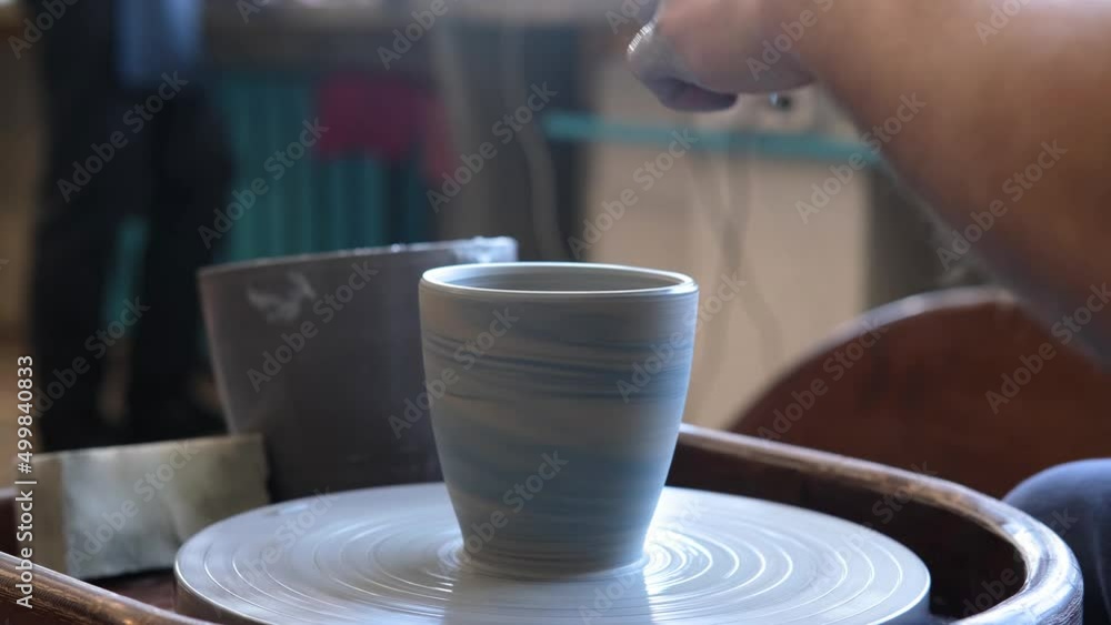 Slow motion video of male potter hands molding clay in pottery workshop. Slow motion video of male potter hands molding clay in pottery workshop.