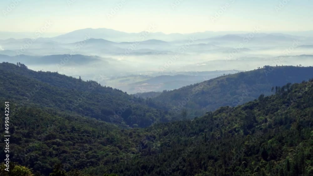 mountainscape with green tropical forest, misty valley on sunny day mountainscape with green tropical forest, misty valley on sunny day