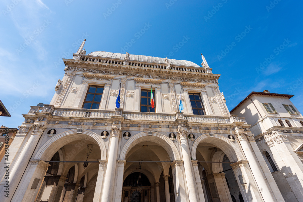 Brescia downtown. Ancient Loggia Palace (Palazzo della Loggia) in Renaissance Style, 1492-1574, in Loggia town square (Piazza della Loggia). Lombardy, Italy, Southern Europe.